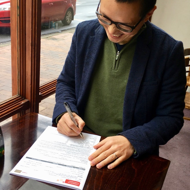 Alex signing the contract for the digital press