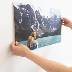 Panoramic landscape print being put on a wall